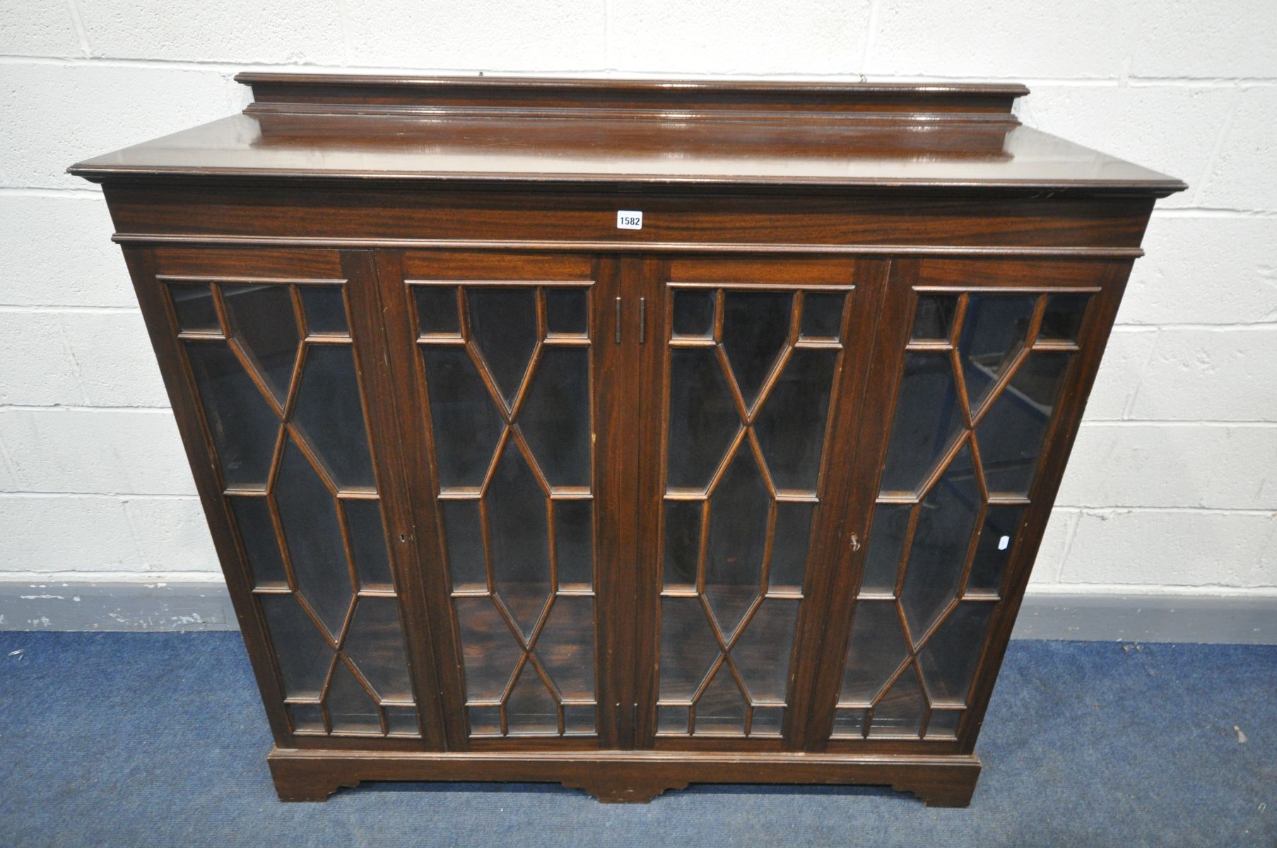 A MAHOGANY ASTRAGAL GLAZED FOUR DOOR BOOKCASE, enclosing two division, and two adjustable shelves,