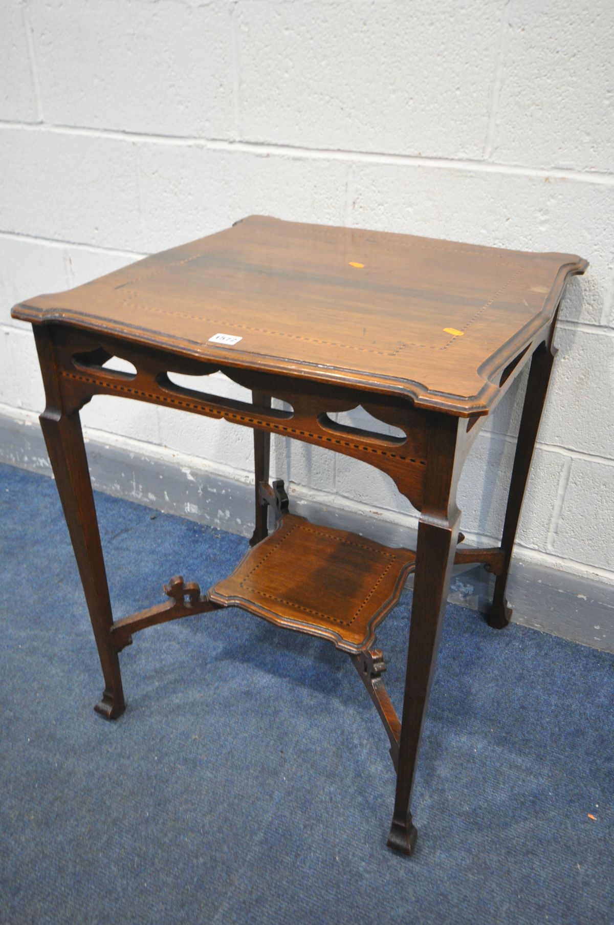 AN EARLY 20TH CENTURY OAK AND STRUNG SQUARE OCCASSIONAL TABLE, with shaped corners, pierced friezes,