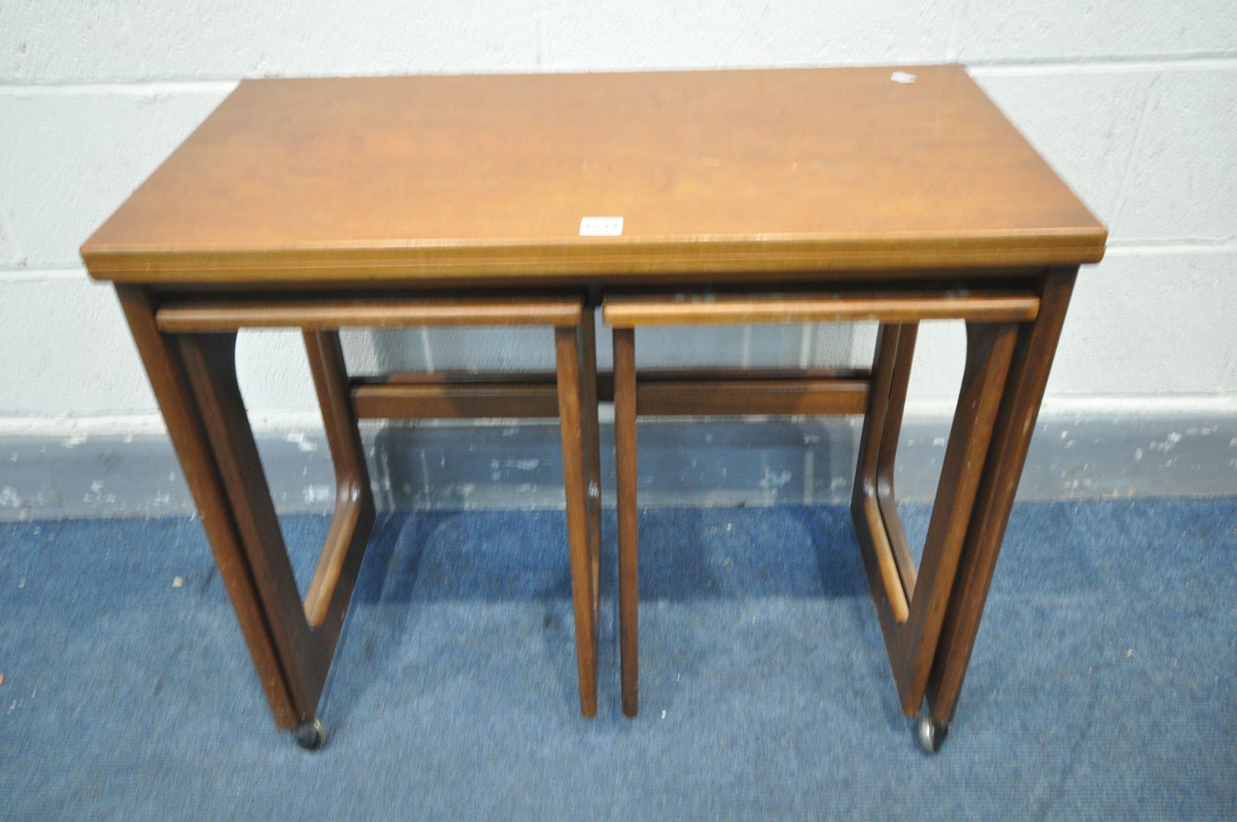 A MCINTOSH TRIFORM TEAK NEST OF THREE TABLES, with a fold over top, width 76cm x depth 41cm x height