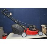 A SOVEREIGN PETROL LAWN MOWER with a Briggs and Stratton 450 series engine (engine pulls freely