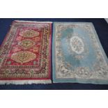 A GREEN CHINESE RUG, 185cm x 127cm, and a red ground rug (2)