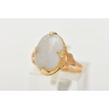 A CHINESE YELLOW METAL OPAL RING, centring on a large white opal cabochon showing flashes of red,