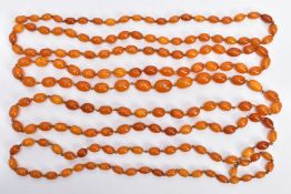 A BUTTERSCOTCH IMITATION AMBER NECKLACE, graduating in size oval beads, fitted to a long double