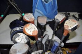 A SELECTION OF GOLFING EQUIPMENT to include two golf bags containing various clubs, a manual/push