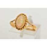 AN 18CT GOLD OPAL RING, designed with an oval cut white opal cabochon, showing flashes of red,