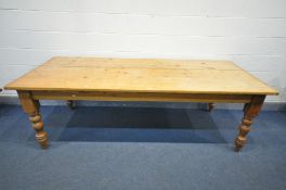 A 20TH CENTURY PINE KITCHEN TABLE, on turned legs, length 234cm x depth 96cm x height 77cm (