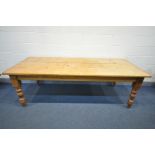 A 20TH CENTURY PINE KITCHEN TABLE, on turned legs, length 234cm x depth 96cm x height 77cm (