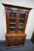 A LATE VICTORIAN WALNUT GLAZED BOOKCASE, with fitted cornice, three shelves, base with a single