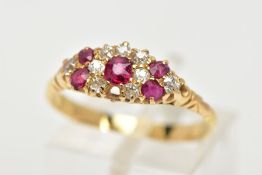 A YELLOW METAL RUBY AND DIAMOND RING, of a marquise shape set with a central circular cut ruby