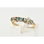 A 9CT GOLD GEM SET HALF HOOP RING, designed with a row of five circular cut aquamarines, cross