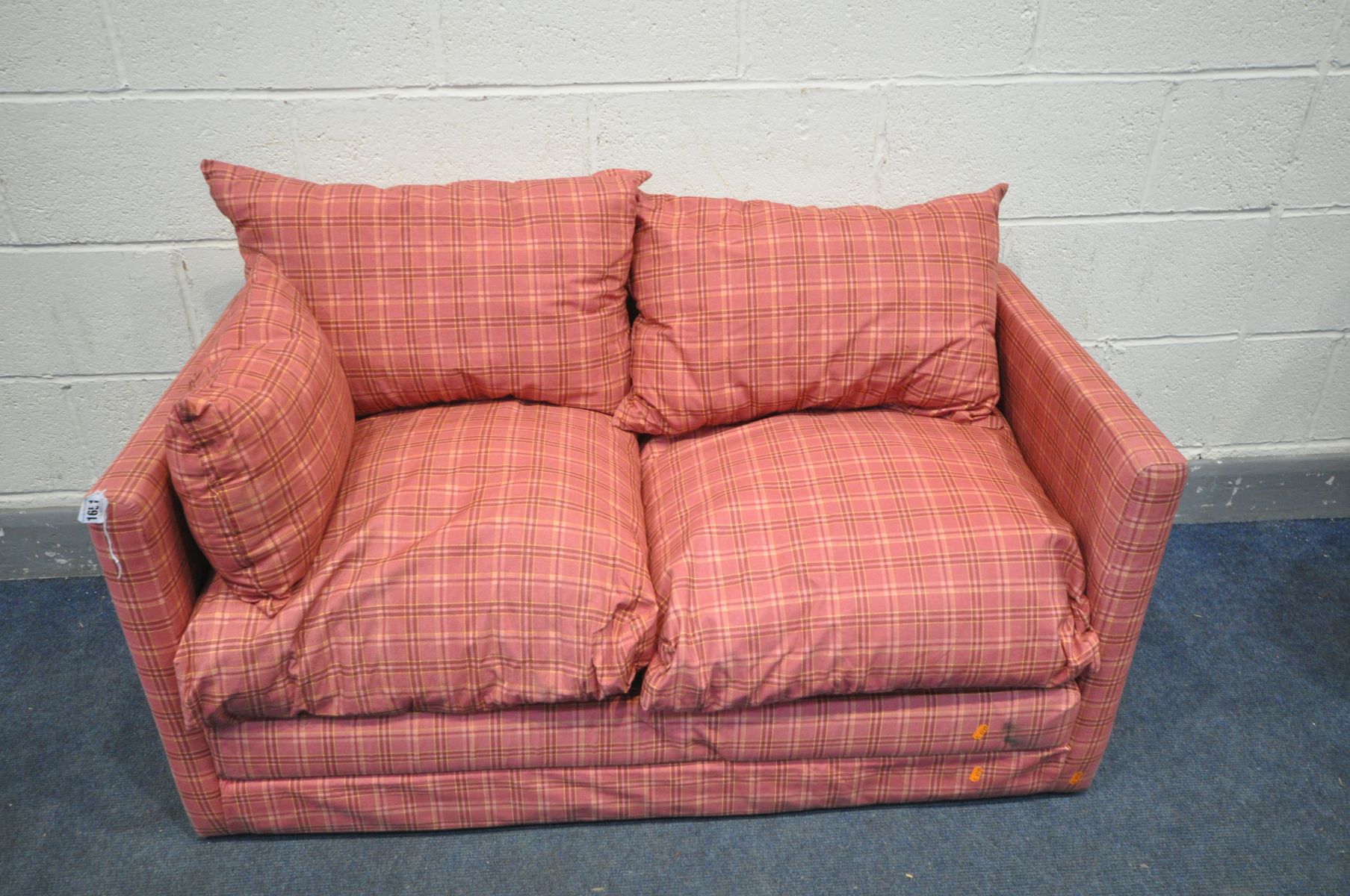 A RED TARTAN UPHOLSTERED TWO SEATER FUTON, length 125cm