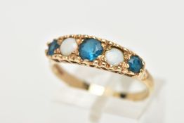 A 9CT GOLD FIVE STONE RING, set with a row of three circular cut blue stones, interspaced with two