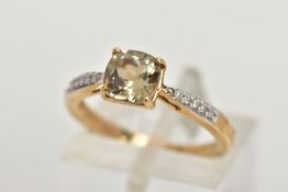 A 9CT GOLD GEM SET RING, designed with a central square cut pale green stone, flanked with diamond