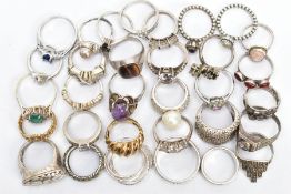 AN ASSORTMENT OF SILVER AND WHITE METAL RINGS, a silver gold plated dome ring, hallmarked Birmingham
