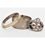 TWO BANGLES AND A SCOTTISH BROOCH, the first a silver hinged bangle decorated with a diamond cut