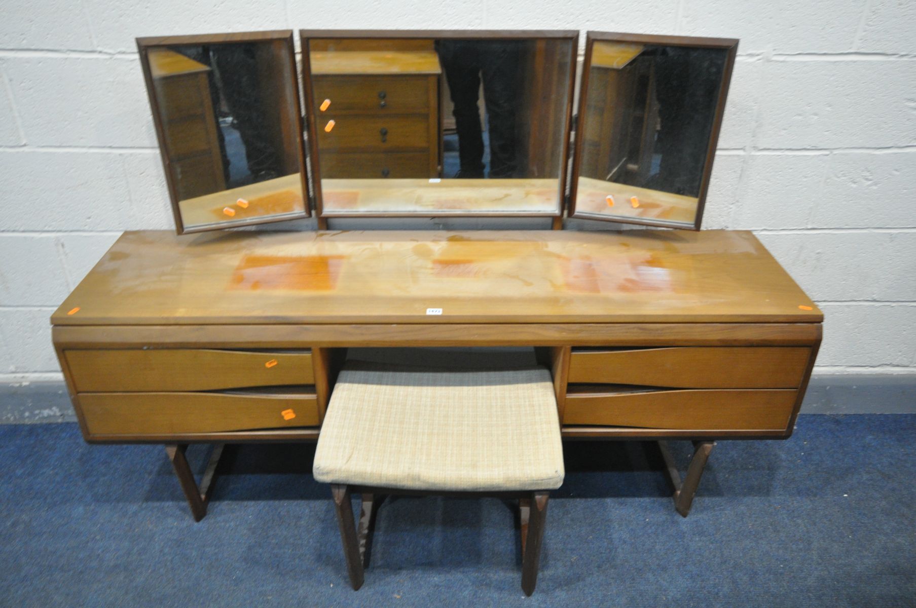 A MID CENTURY WHITE AND NEWTON DRESSING TABLE, with a triple dressing mirror, four drawer, on twin