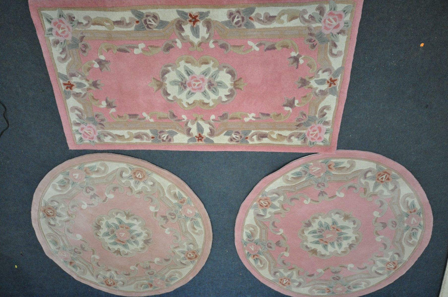 TWO CHINESE PINK CIRCULAR RUGS, diameter 122cm, a similar rectangular rug, and a cream half-moon rug - Image 2 of 2