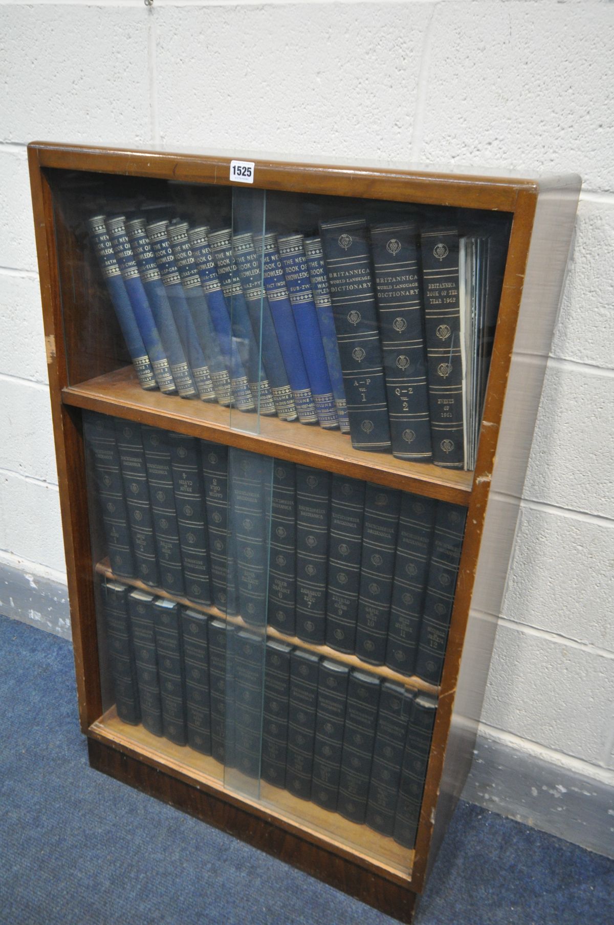 A GLAZED BOOKCASE, containing the Britannica Dictionary, the new book of Knowledge and Encyclopaedia
