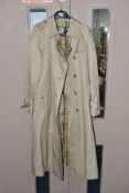 A LADIES DOUBLE BREASTED BURBERRY THREE QUARTER LENGTH TRENCH COAT, khaki / stone outer with