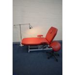 A RED LEATHER ELECTRIC SPORTS MASSAGE TABLE, that's suitable for Therapy, physio and osteopathy,