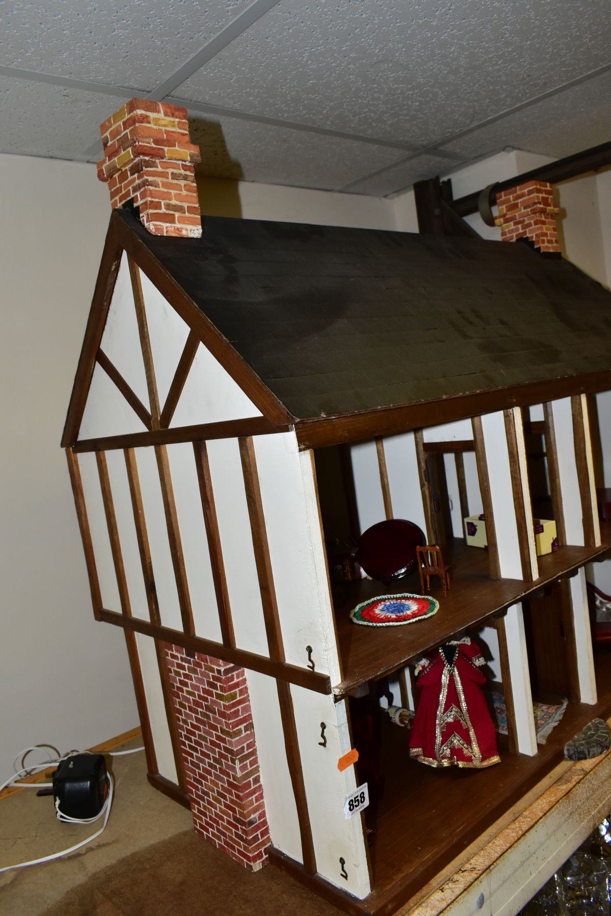 A DOLLS HOUSE, exterior in Tudor style, with four rooms, hallway, stairs and landing, a two - Image 4 of 5