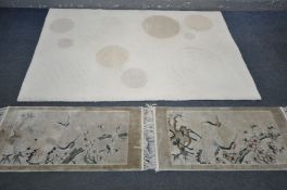 A MODERN CREAM RUG, manufactured by KC Rugs, design Circles, 180cm x 120cm, and two small oriental