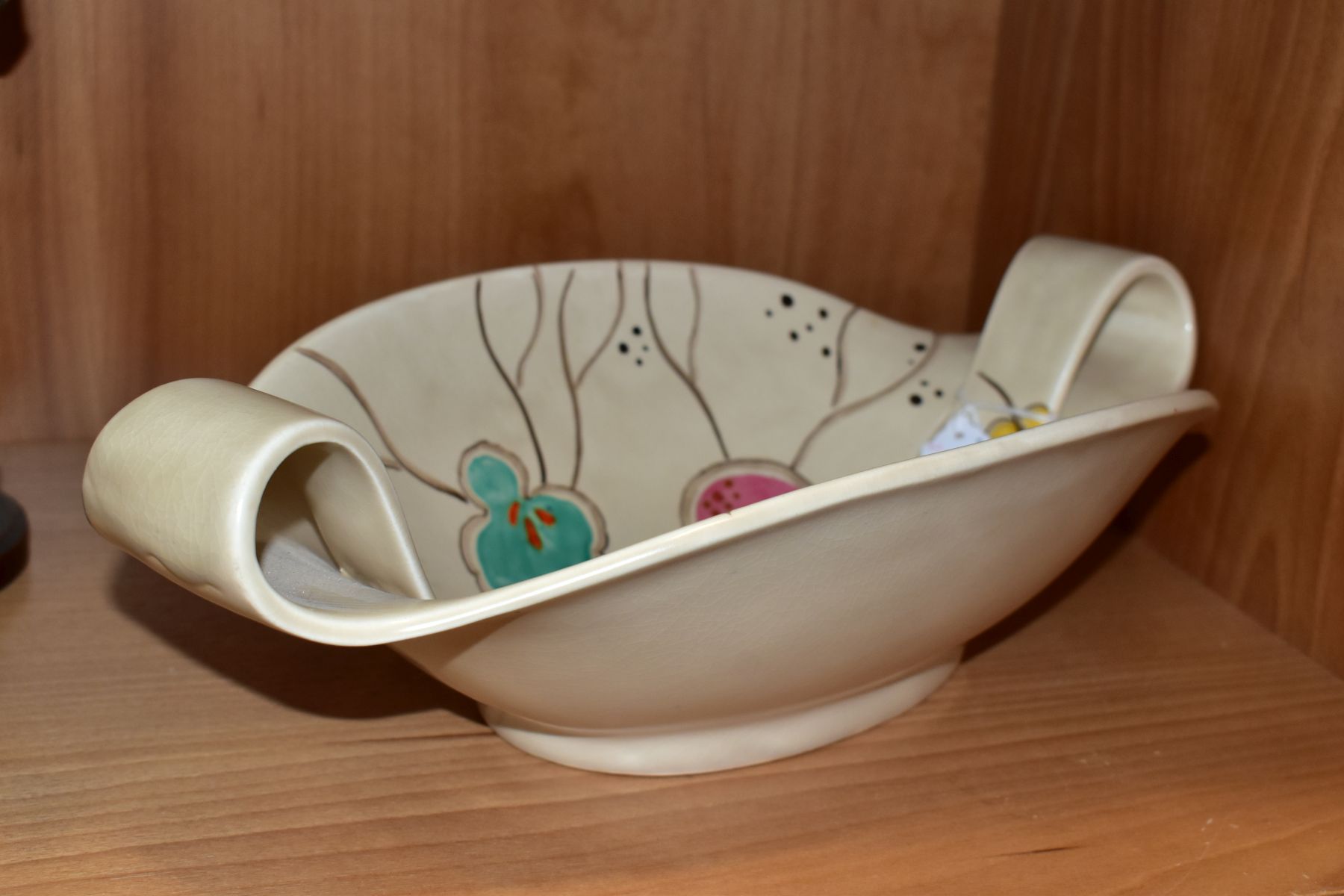 A CLARICE CLIFF WILKINSON LTD POTTERY TWIN HANDLED OVAL BOWL PAINTED WITH A FRUITING POMEGRANATE - Image 3 of 4