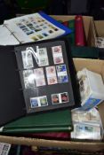 TWO BOXES OF STAMPS IN FIFTEEN ALBUMS, chiefly GB mint and used QEII as singles, first day covers