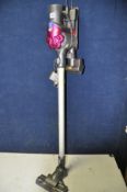 A DYSON CORDLESS VACUUM model No DC35ANIMAL with charging dock and accessories (PAT pass and