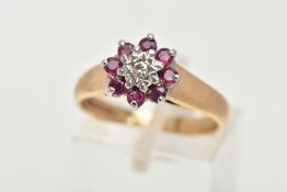A 9CT GOLD RUBY AND DIAMOND CLUSTER RING, flower shape cluster set with a central round brilliant