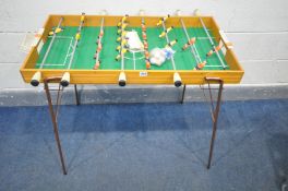 A FRENCH TABLE FOOTBALL TABLE, on folding metal legs, along with playing balls, length 110cm x depth