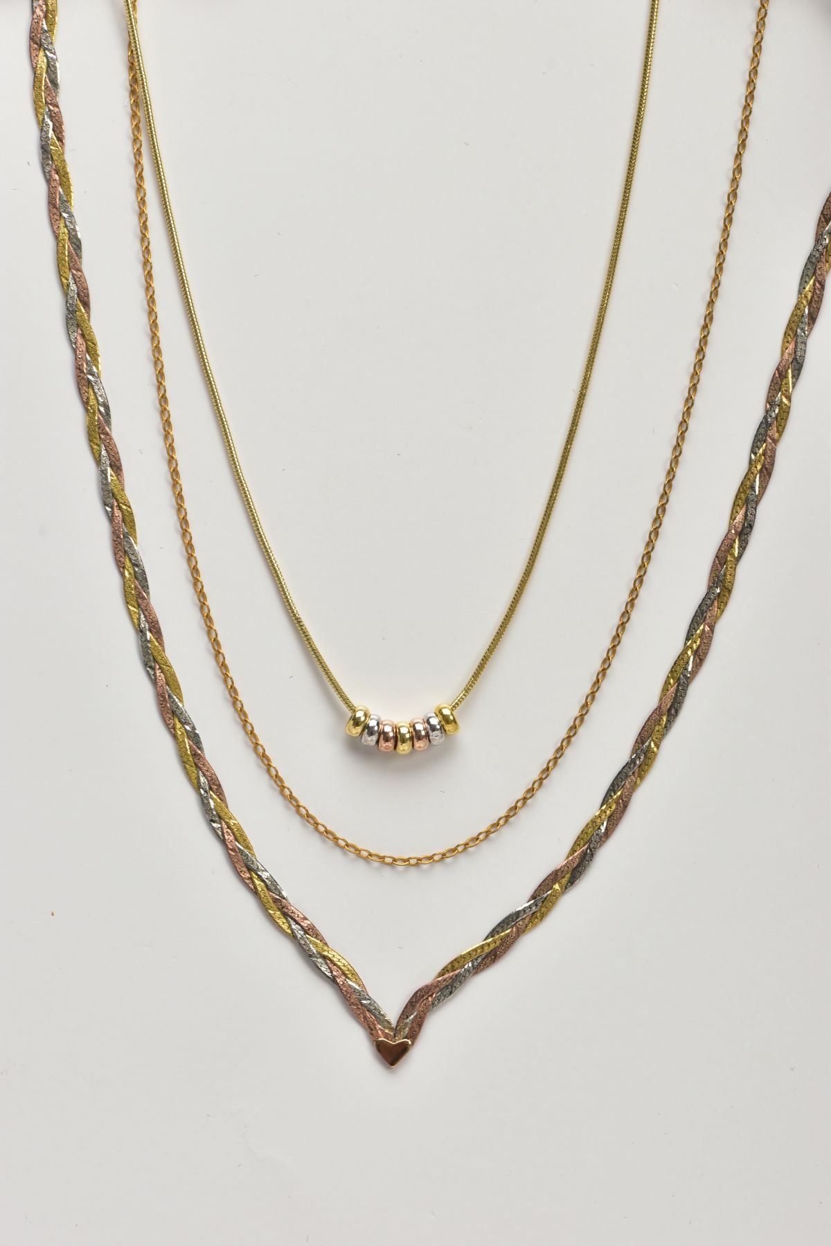 THREE 9CT GOLD NECKLACES, the first a tri-colour plaited V-shape chain fitted with a spring clasp - Image 2 of 3