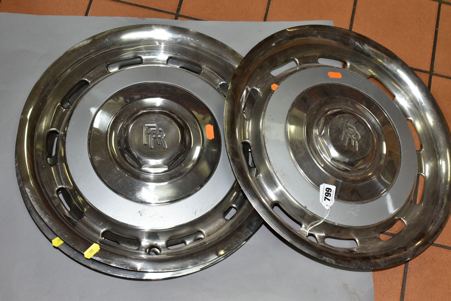 A SET OF FOUR CHROME ROLLS ROYCE HUB CAPS, diameter 42.5cm, with light grey band and central Rolls