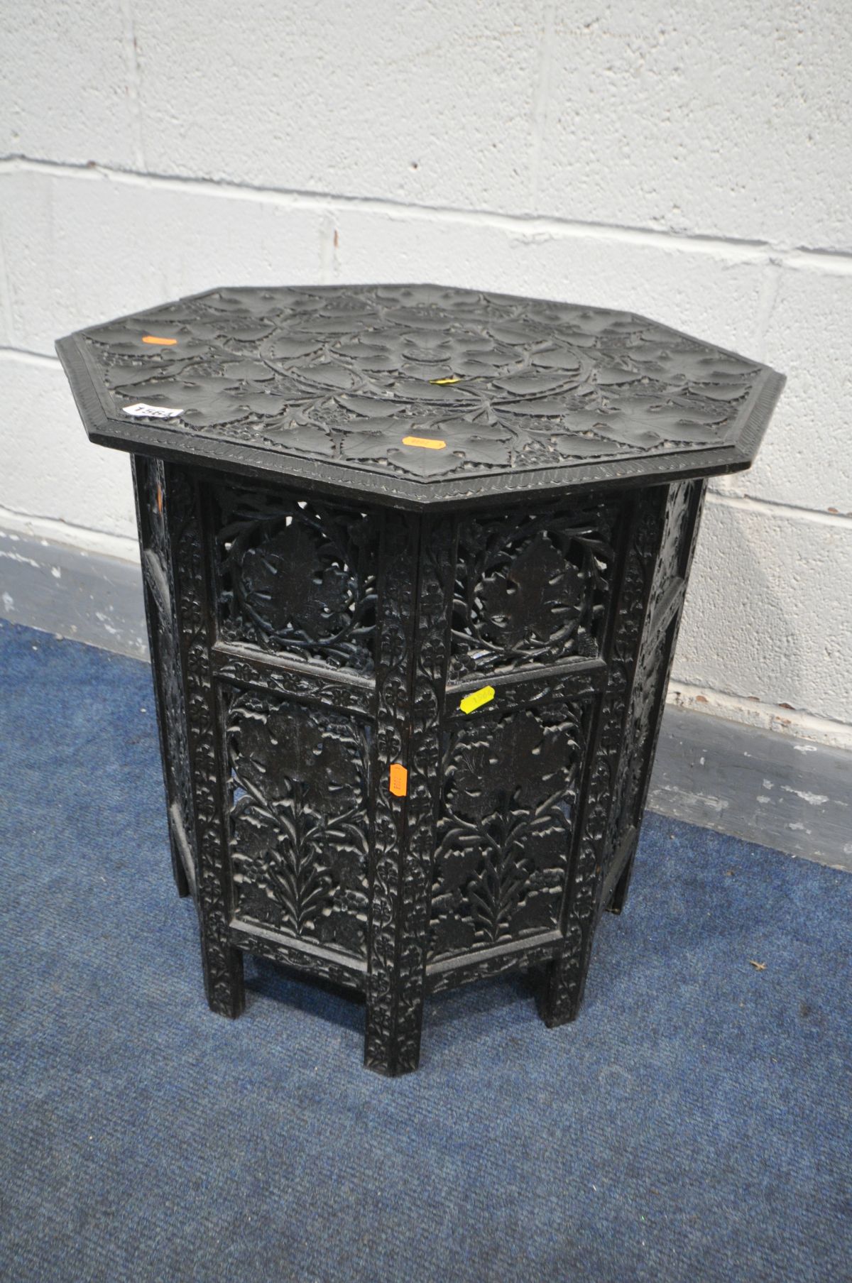 AN ANGLO INDIAN OCTAGONAL OCCASIONAL TABLE, on a separate folding base with open fretwork detail,