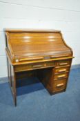 AN INDIANAPOLIS OAK SINGLE PEDASTAL ROLL TOP DESK, with four internal drawers including two secret