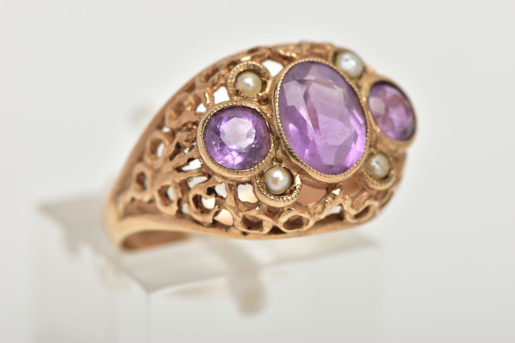 A YELLOW METAL AMETHYST AND SEED PEARL DRESS RING, centring on an oval cut amethyst milgrain - Image 4 of 4