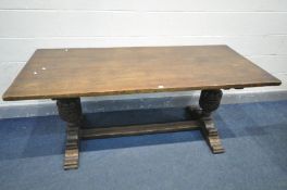 A REPRODUCTION OAK REFECTORY DINING TABLE, on twin acorn legs, united by a floor stretcher, length