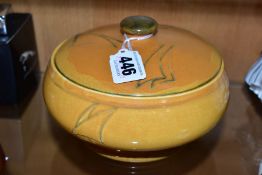 A WILLIAM MOORCROFT YACHT PATTERN SAUCE TUREEN AND COVER IN AN OCHRE GLAZE, the cover with cut