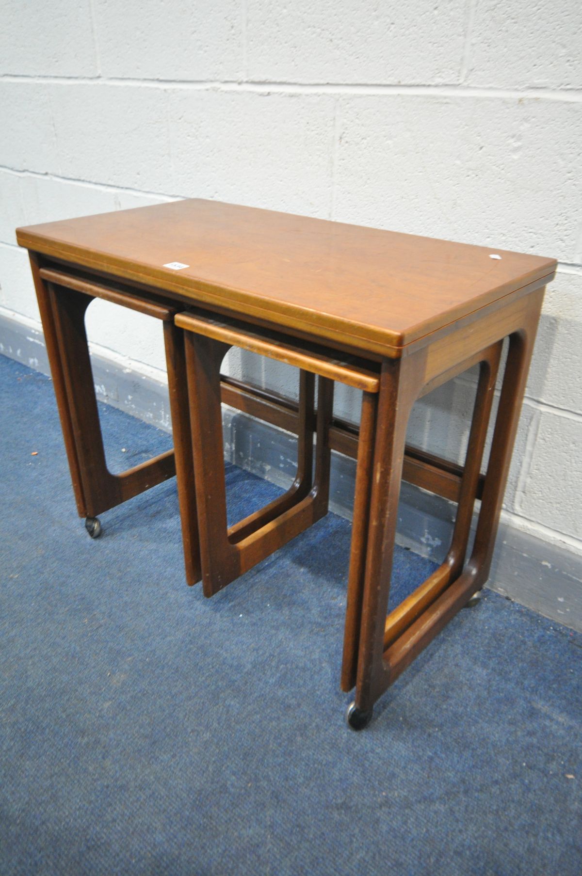A MCINTOSH TRIFORM TEAK NEST OF THREE TABLES, with a fold over top, width 76cm x depth 41cm x height - Image 2 of 3