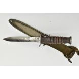 AMERICAN WORLD WAR TWO ERA M3 FIGHTING KNIFE, in metal and canvas scabbard, the knife cross guard is