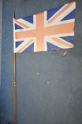 A LARGE UNION JACK WITH FLAG POLE, height 252cm (condition:-flag distressed)