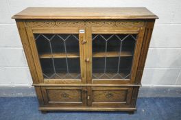 AN OAK LEAD GLAZED TWO DOOR BOOKCASE, width 94cm x depth 26cm x height 99cm (condition:-fluid