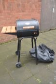 A CHAR-GRILLER PROFESSIONAL METAL BARBECUE in barrel form with side shelf, undershelf and cover,