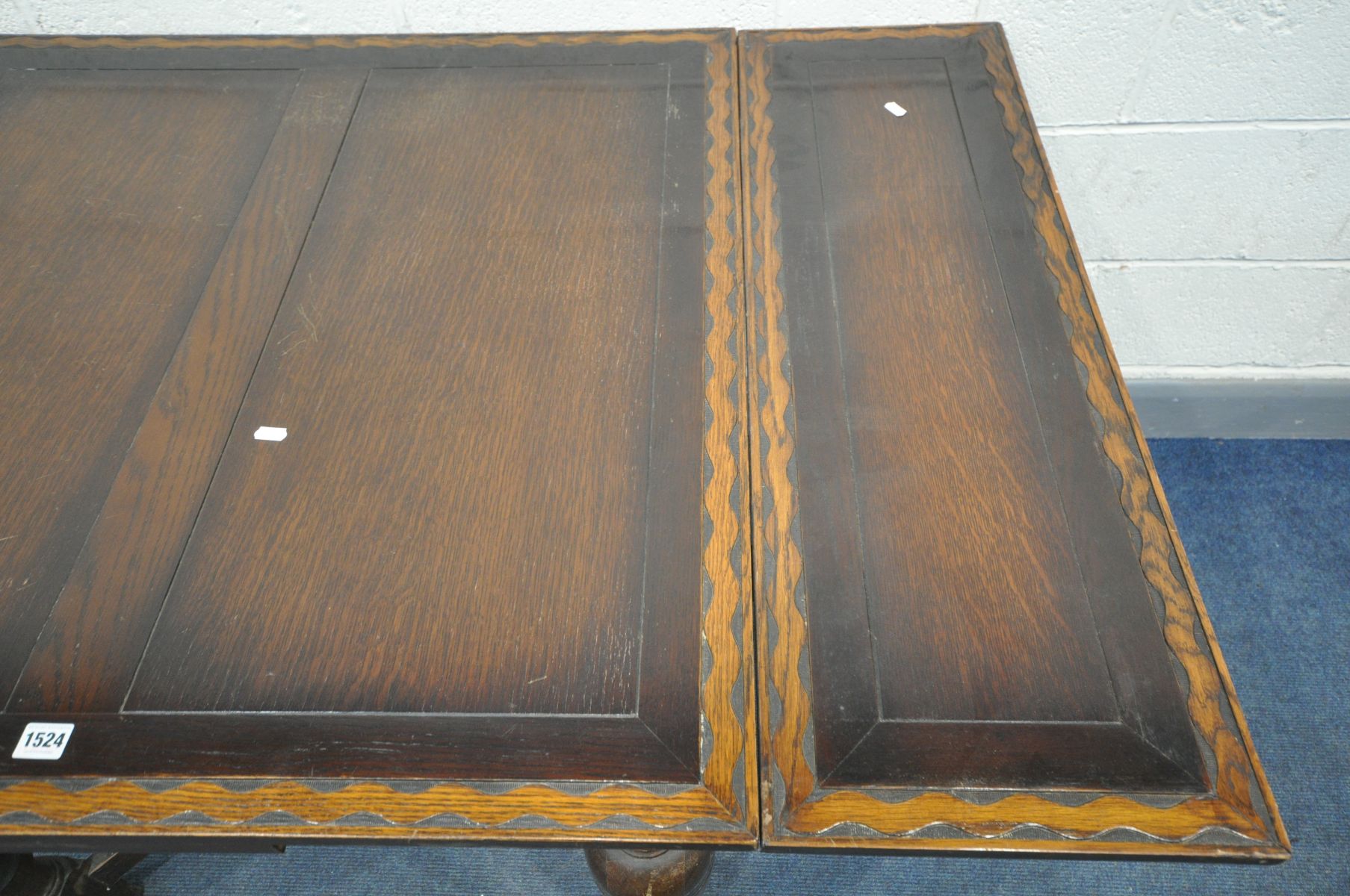 AN OAK DRAW LEAF DINING TABLE, with a wavy carved border, on bulbous legs, united by a cross - Image 2 of 4