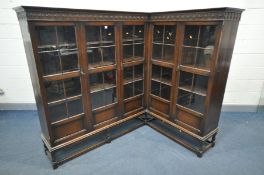 AN EARLY 20TH CENTURY OAK GLAZED CORNER BOOKCASE, possibly made by Waring & Gillow of Lancaster,