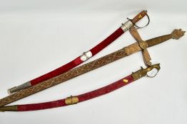 TWO ASIAN/INDIAN TOURIST STYLE CURVED SWORDS in wooden and suede scabbards, one id marked made in