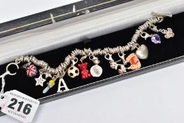 A WHITE METAL CHARM BRACELET AND CHARMS, white metal rings fitted to a white metal chain bracelet,