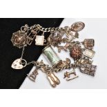 A SILVER CHARM BRACELET, curb link bracelet fitted with twenty charms in forms such as a money