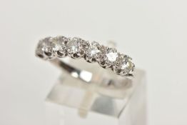 AN 18CT WHITE GOLD DIAMOND HALF ETERNITY RING, set with seven round brilliant cut diamonds in a