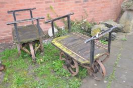 A PAIR OF CAST IRON OPEN PIT TROLLEYS with wooden iron banded beds, handles front and back with 4